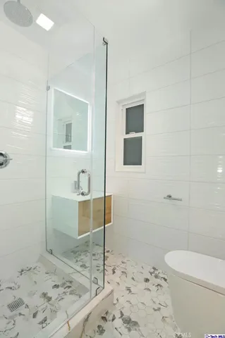 a bathroom with a tub sink and shower