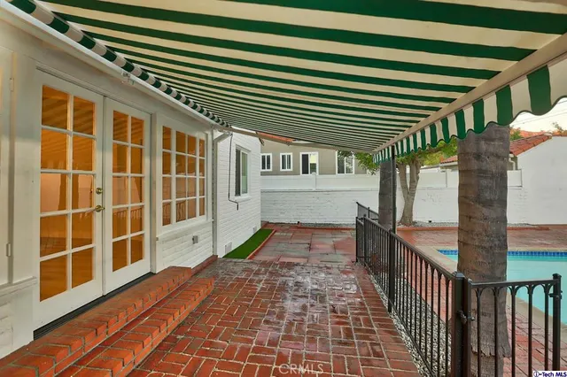a backyard of a house with table and chairs