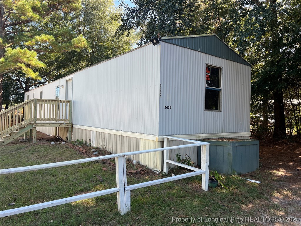 a view of backyard with deck and outdoor seating