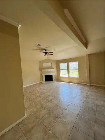 a view of empty room with a fireplace