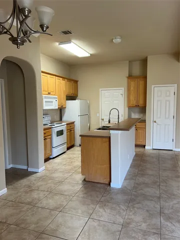 a kitchen with appliances cabinets and a sink