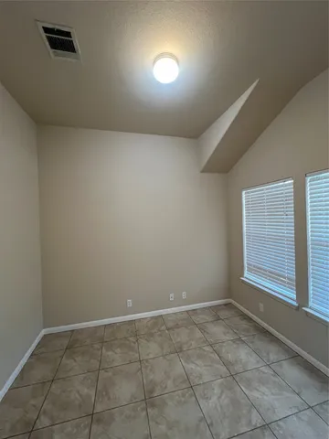 a kitchen with cabinets and window