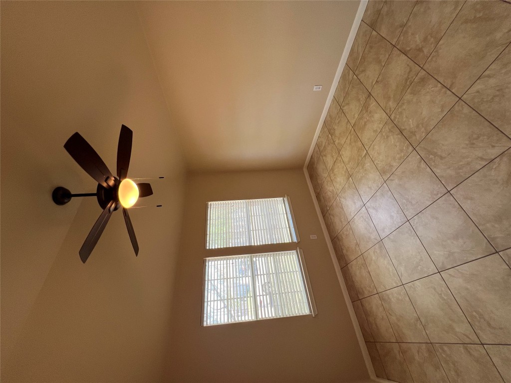 129 Holmstrom Street Hutto, TX 78634 - Photo 12 of 26 Primary Bedroom with baseboards, a ceiling fan, and light tile patterned flooring