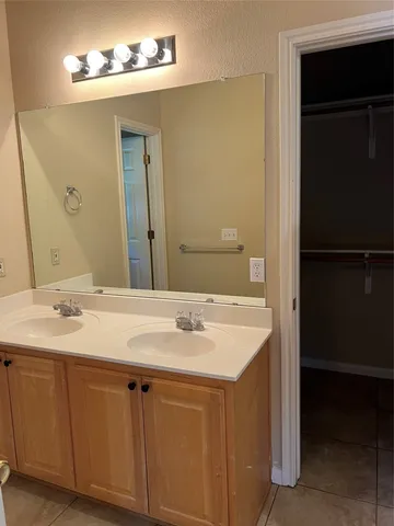a view of an empty room and window and chandelier fan