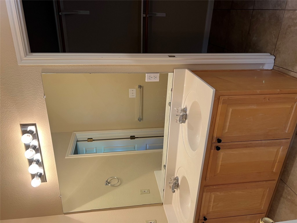 129 Holmstrom Street Hutto, TX 78634 - Photo 13 of 26 Full bath with tile patterned floors, double vanity, a sink, and baseboards