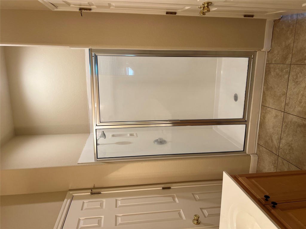 129 Holmstrom Street Hutto, TX 78634 - Photo 15 of 26 Full bathroom with a stall shower, vanity, and tile patterned floors