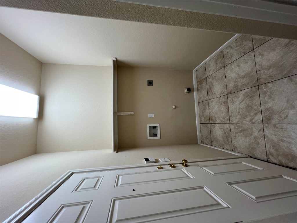 129 Holmstrom Street Hutto, TX 78634 - Photo 20 of 26 Laundry area featuring washer hookup, laundry area, gas dryer hookup, electric dryer hookup, and tile patterned flooring