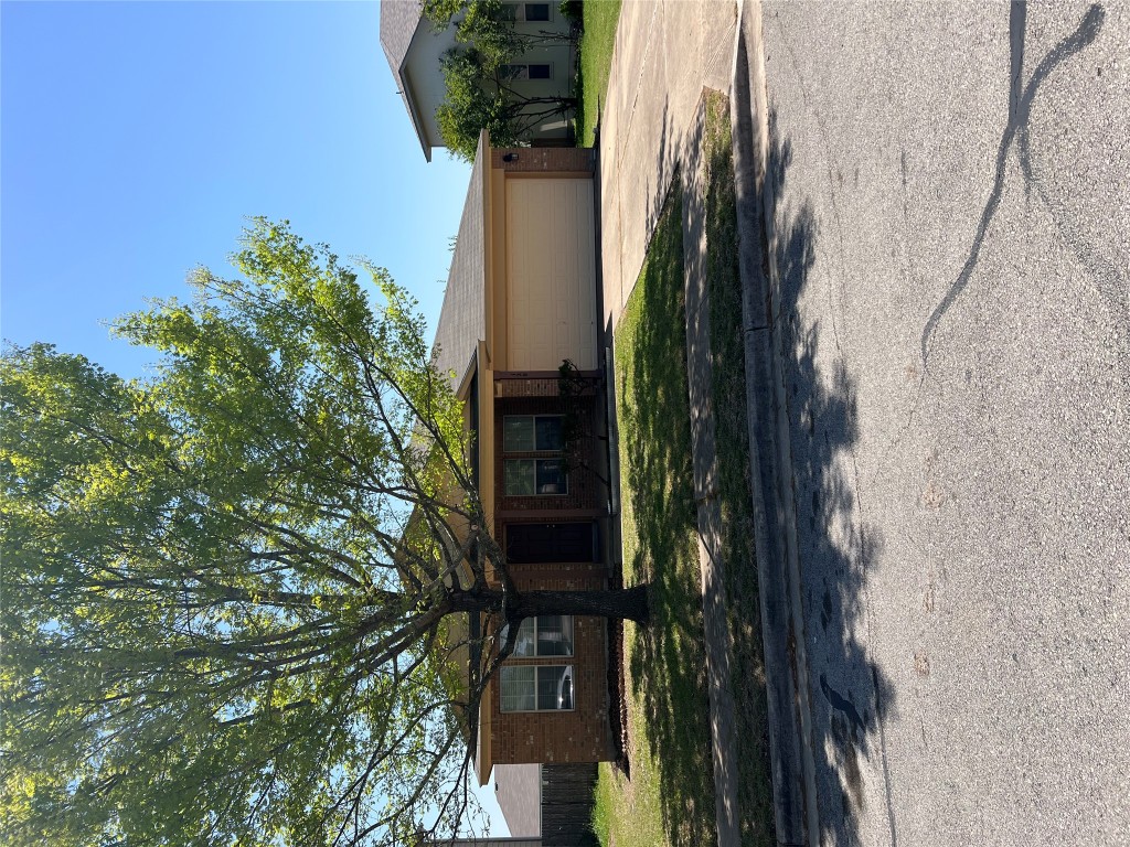 129 Holmstrom Street Hutto, TX 78634 - Photo 22 of 26 Ranch-style house featuring an attached garage, concrete driveway, a front yard, and brick siding