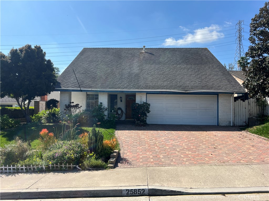 25852 Tree Top Road Laguna Hills, CA 92653 - Photo 1 of 1 a front view of a house with a yard and garage