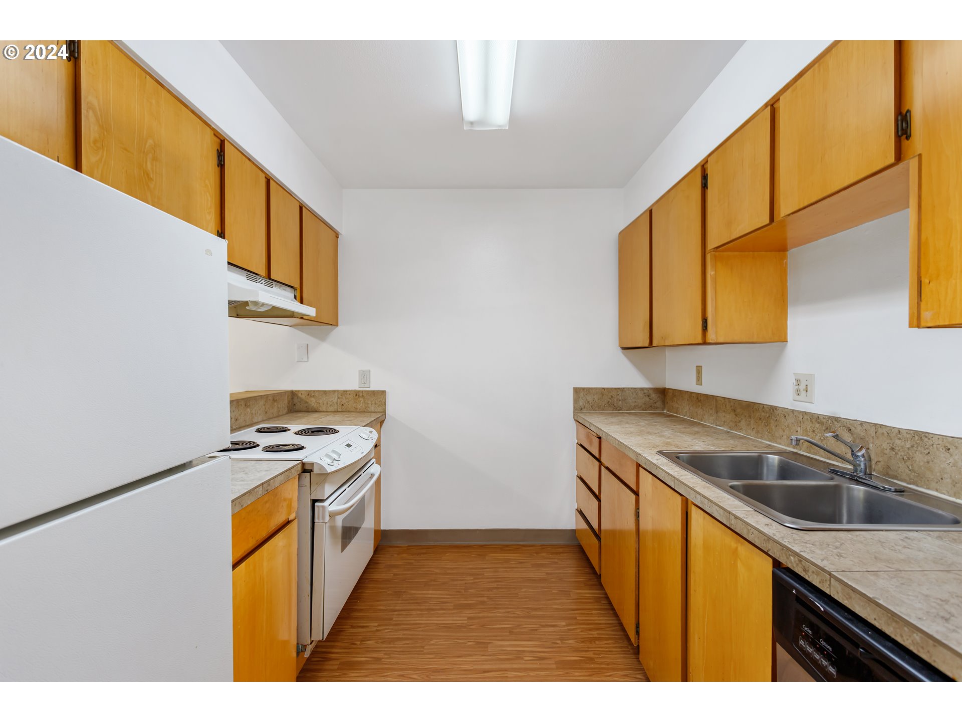 11377 Southwest Springwood Drive, Unit 34 Portland, OR 97223 - Photo 13 of 28 a kitchen that has a sink and a stove