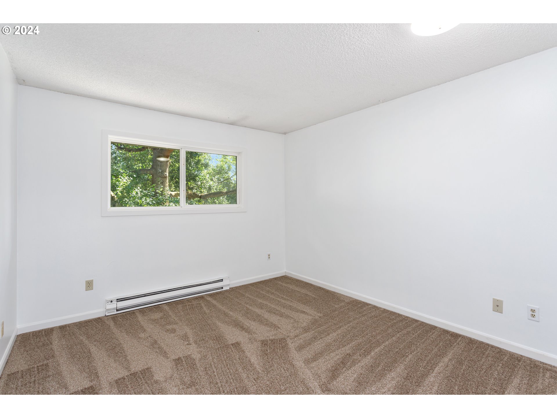 11377 Southwest Springwood Drive, Unit 34 Portland, OR 97223 - Photo 16 of 28 an empty room with a window