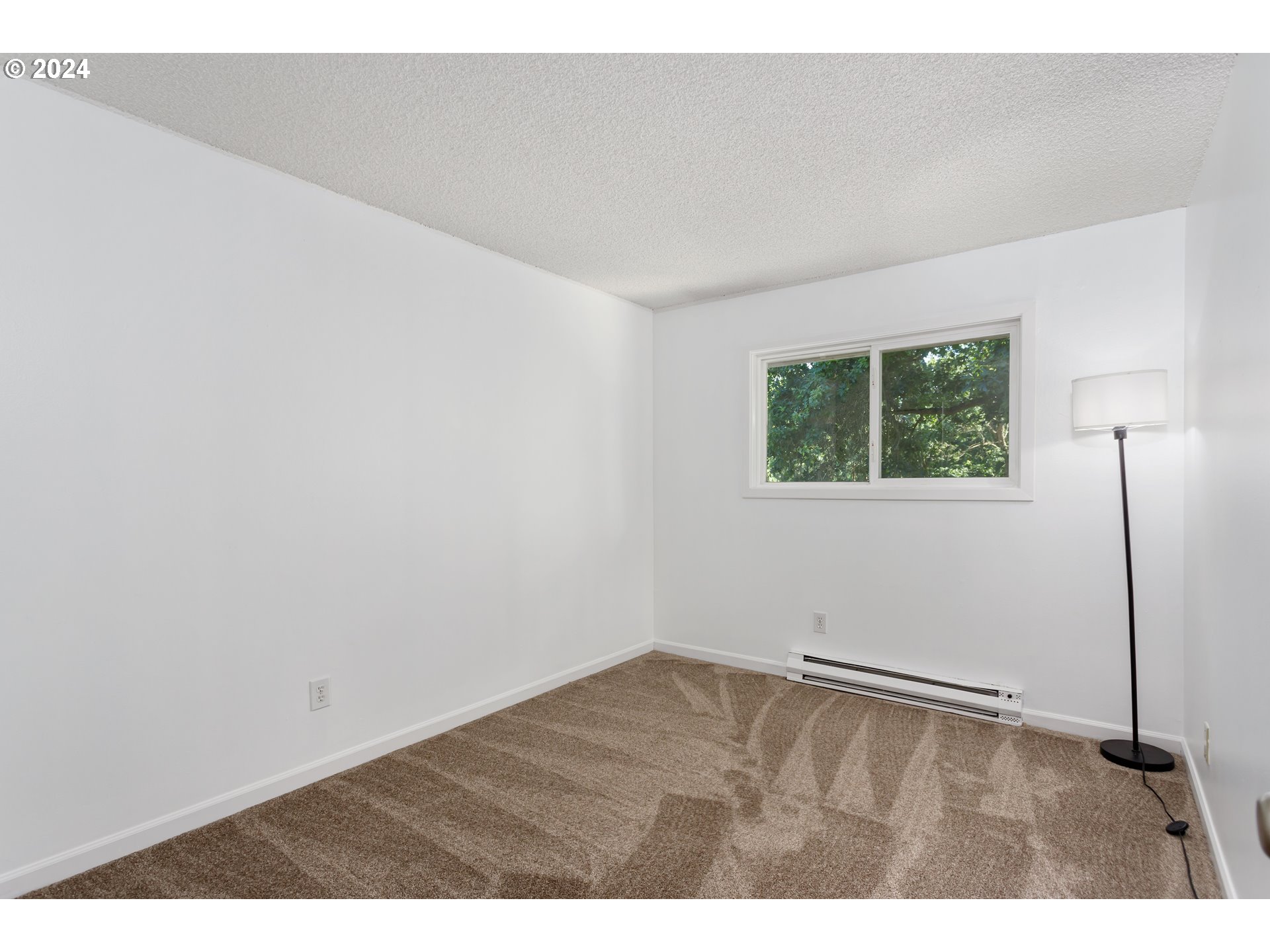 11377 Southwest Springwood Drive, Unit 34 Portland, OR 97223 - Photo 18 of 28 a view of an empty room with a window