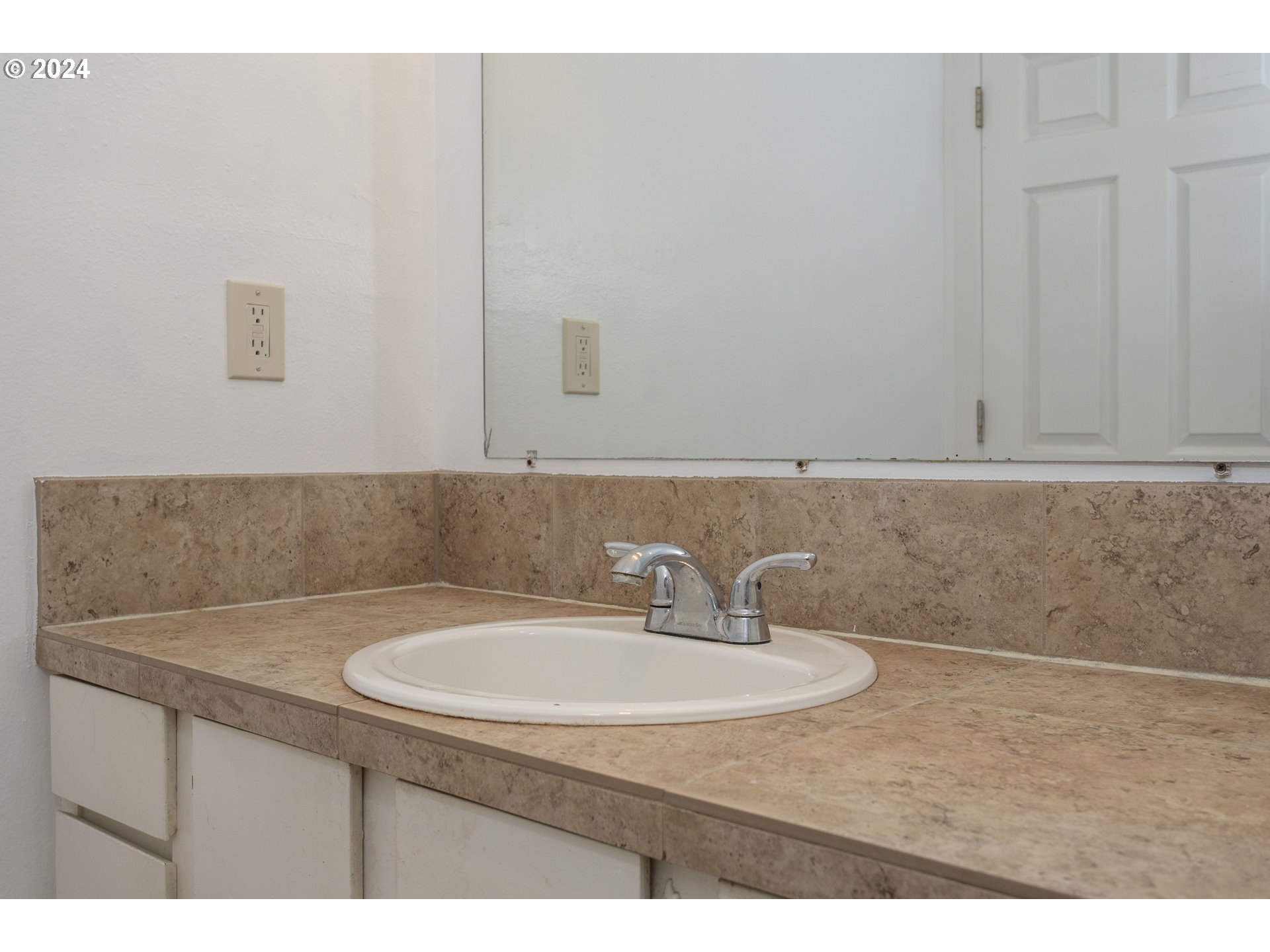 11377 Southwest Springwood Drive, Unit 34 Portland, OR 97223 - Photo 21 of 28 a bathroom with a sink and a mirror
