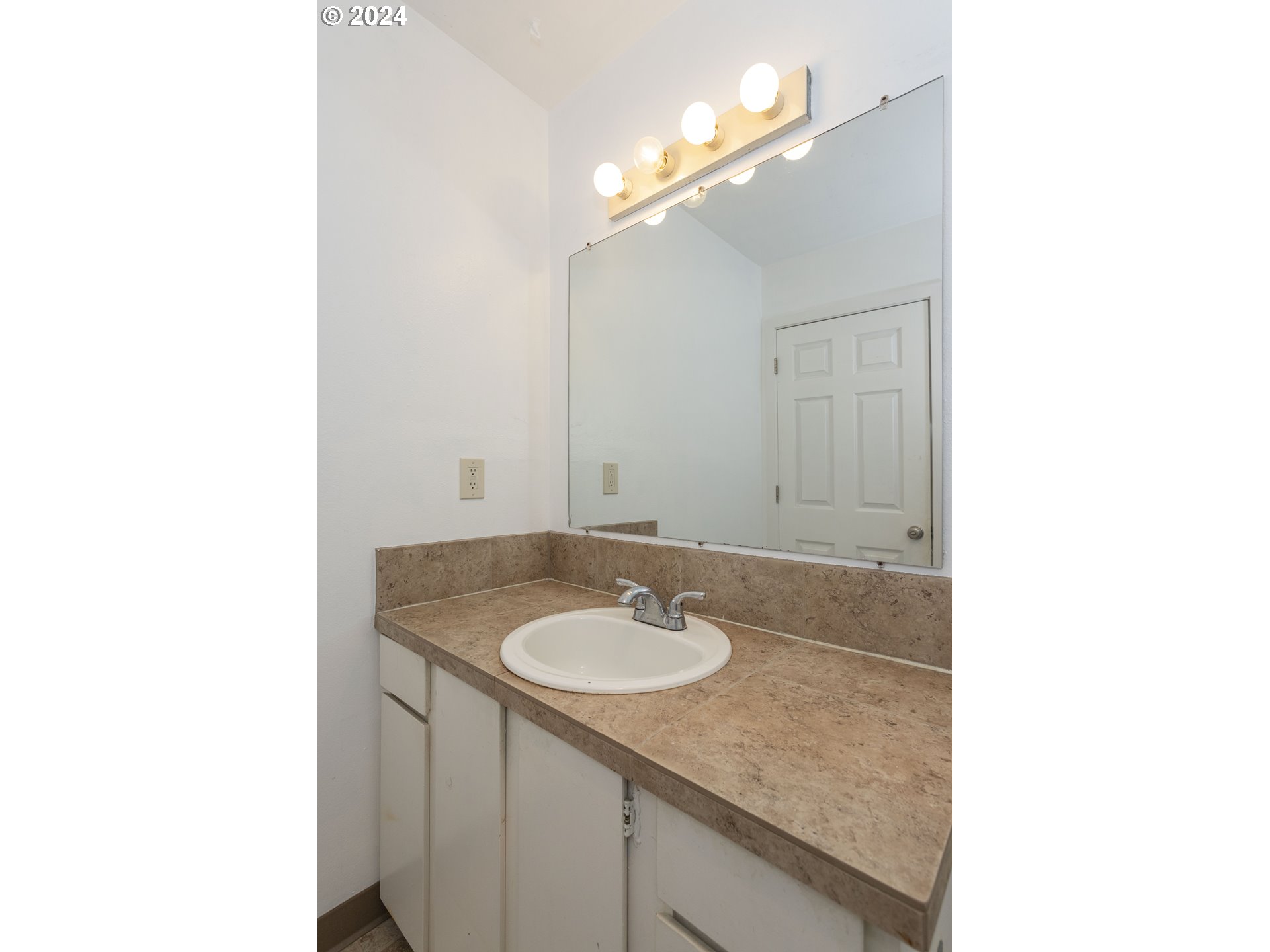11377 Southwest Springwood Drive, Unit 34 Portland, OR 97223 - Photo 22 of 28 a bathroom with a sink and a mirror