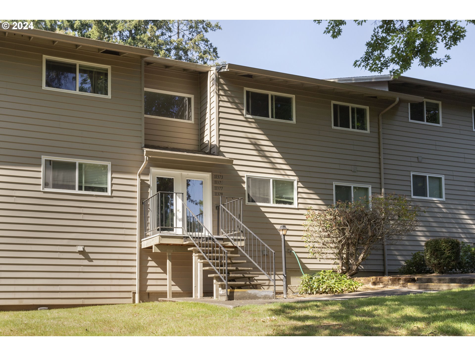 11377 Southwest Springwood Drive, Unit 34 Portland, OR 97223 - Photo 26 of 28 a view of a house with a yard