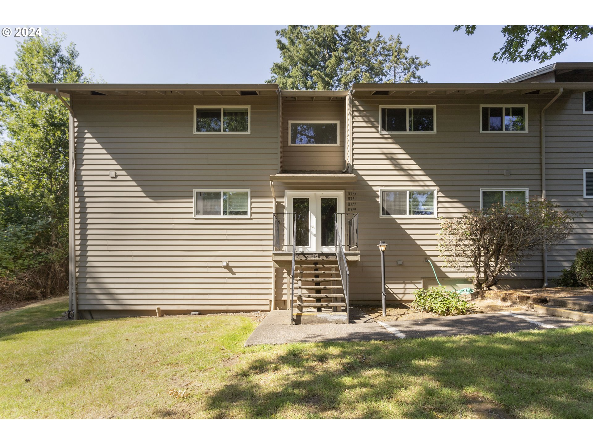 11377 Southwest Springwood Drive, Unit 34 Portland, OR 97223 - Photo 27 of 28 a view of a house with a yard