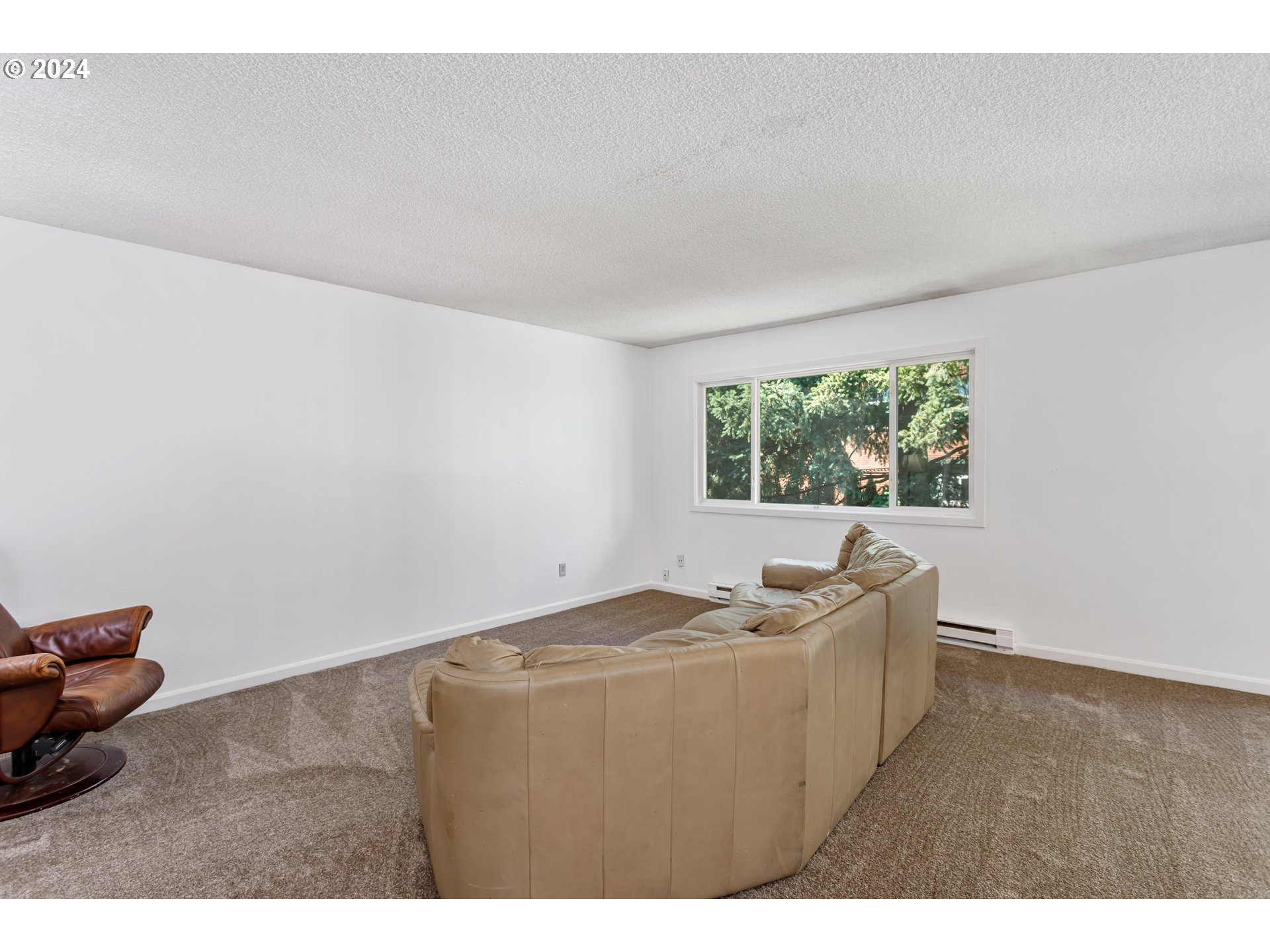 11377 Southwest Springwood Drive, Unit 34 Portland, OR 97223 - Photo 7 of 28 a living room with furniture and a window