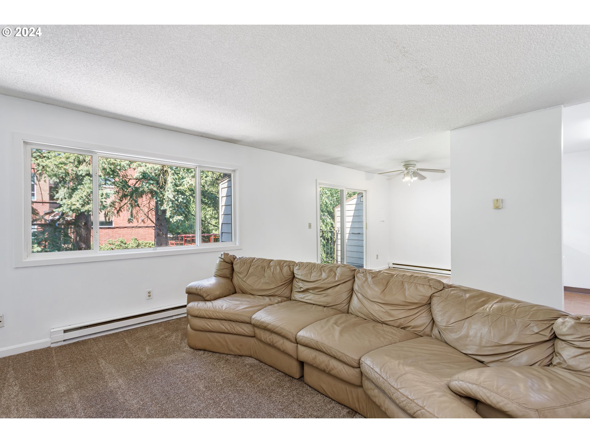 11377 Southwest Springwood Drive, Unit 34 Portland, OR 97223 - Photo 8 of 28 a living room with furniture and a large window