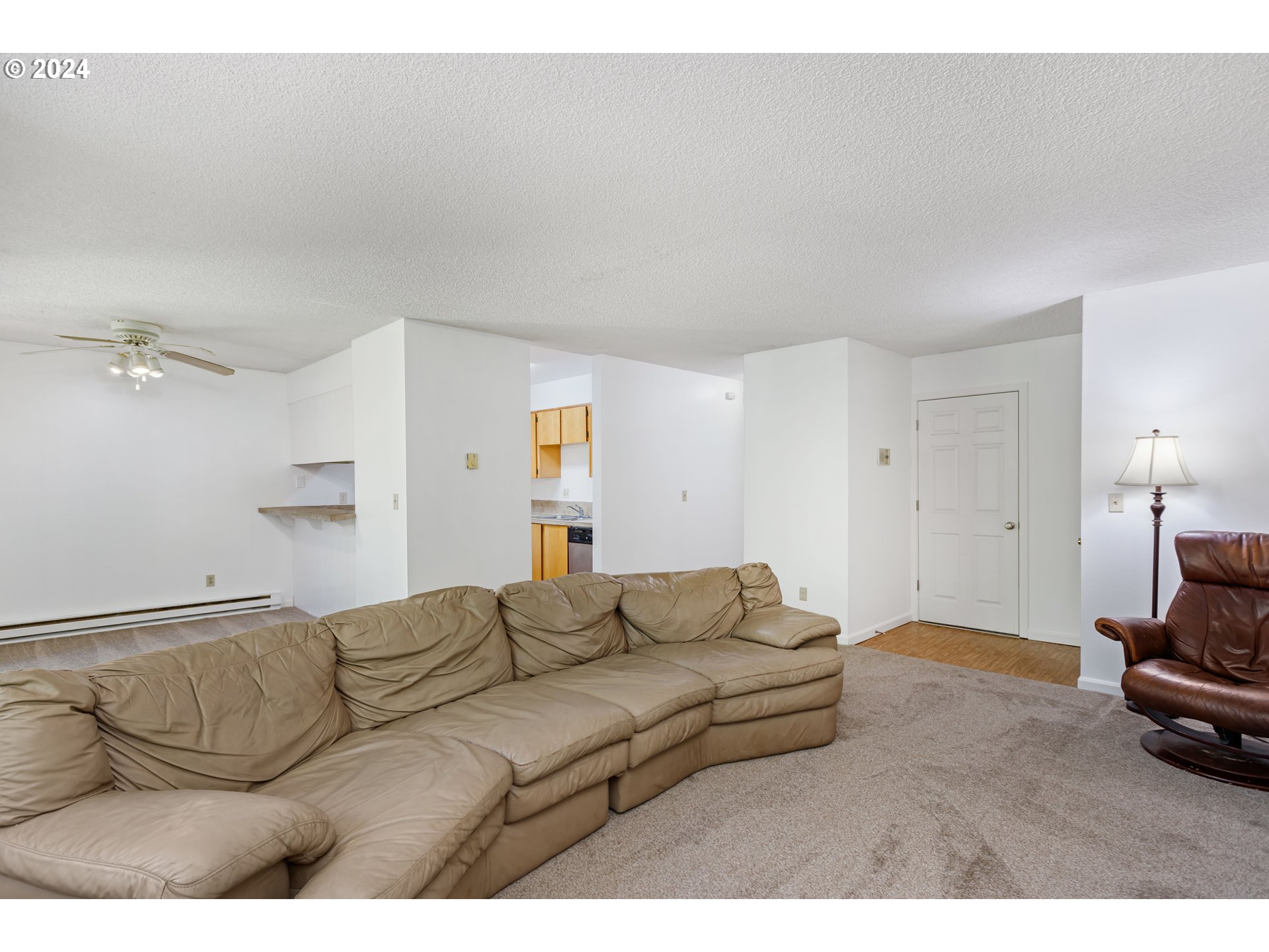 11377 Southwest Springwood Drive, Unit 34 Portland, OR 97223 - Photo 9 of 28 a living room with furniture and a lamp