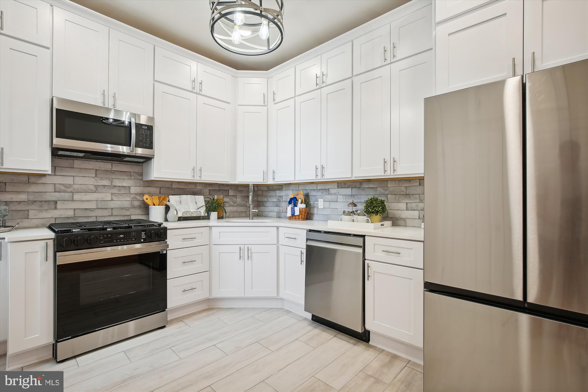 616 E Street Northeast Washington, DC 20002 - Photo 28 of 79 a kitchen with stainless steel appliances granite countertop a stove a refrigerator and a microwave