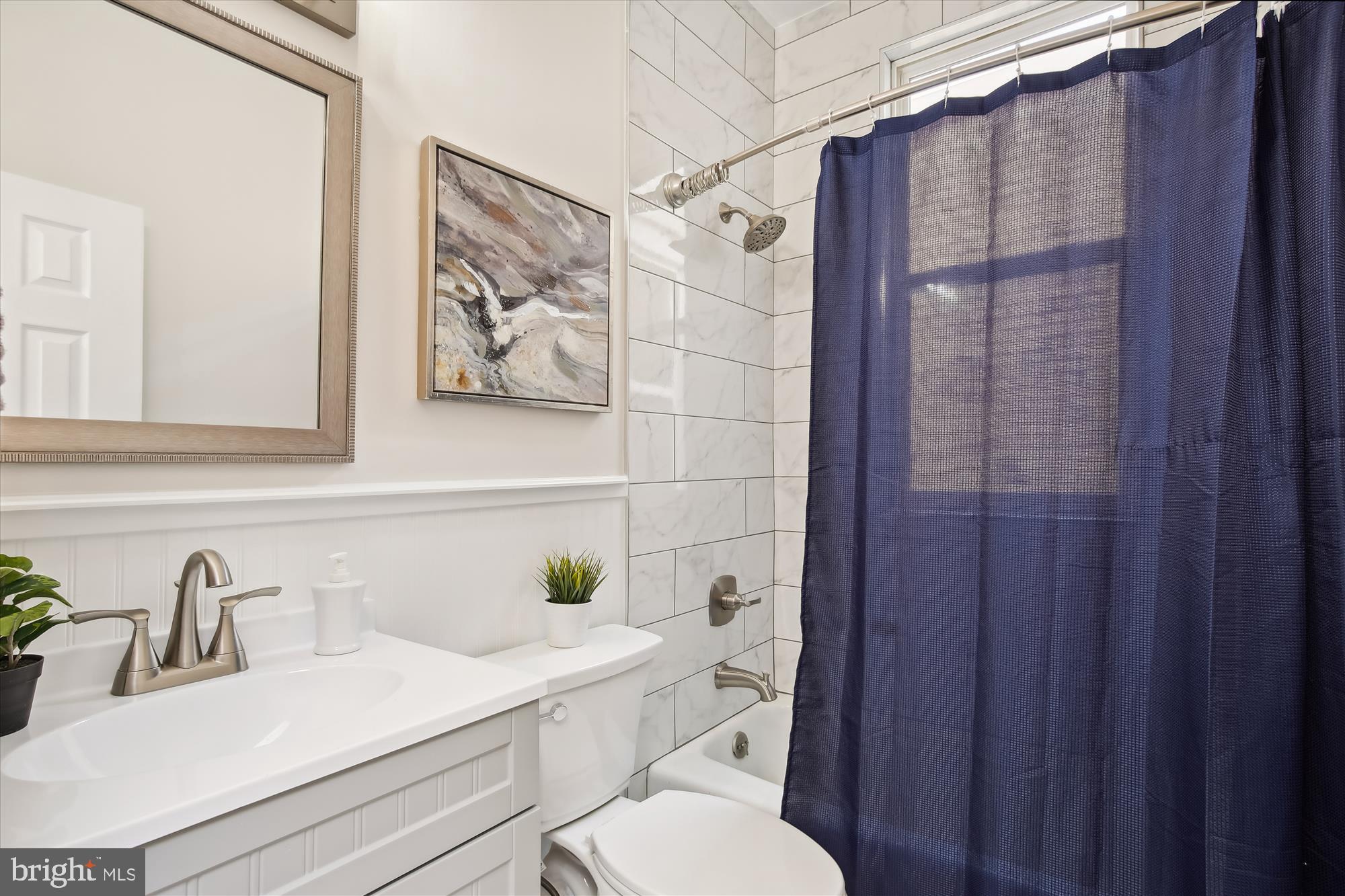 616 E Street Northeast Washington, DC 20002 - Photo 32 of 79 a bathroom with a sink vanity mirror and toilet