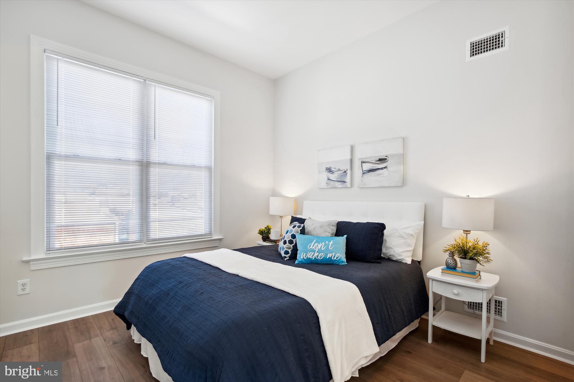 616 E Street Northeast Washington, DC 20002 - Photo 35 of 79 a bedroom with a bed and wooden floor