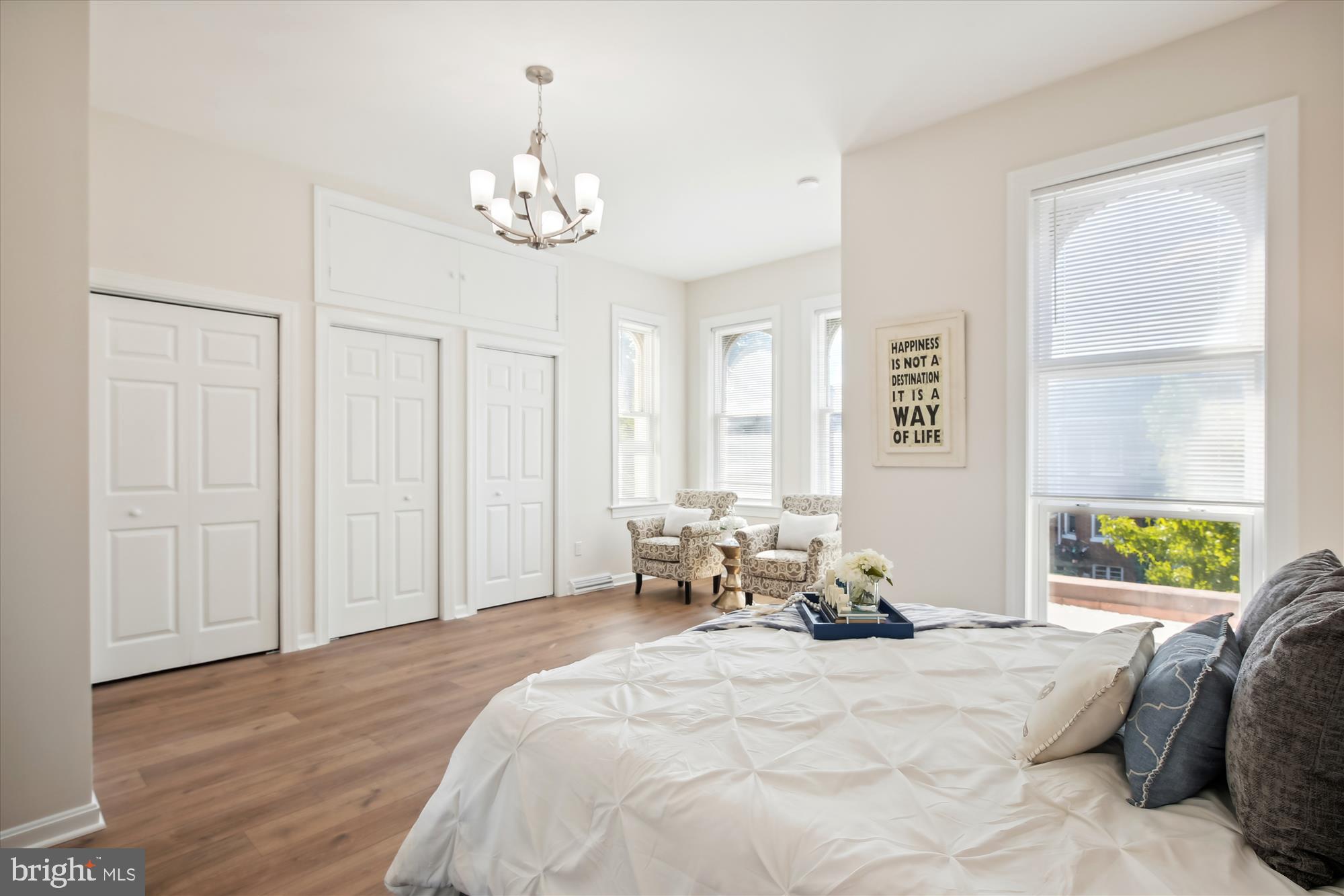 616 E Street Northeast Washington, DC 20002 - Photo 48 of 79 a spacious bedroom with a bed and a chandelier