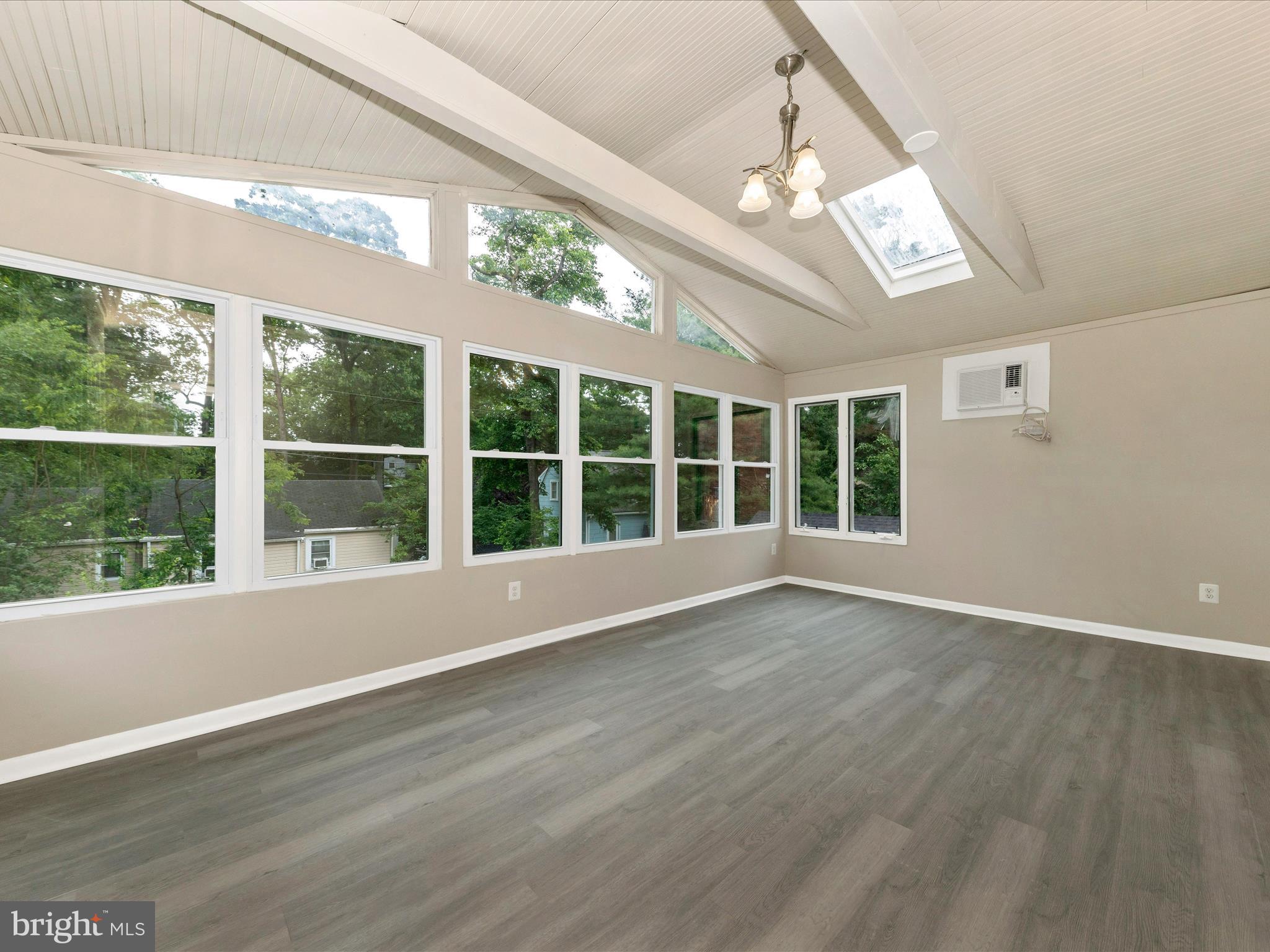 8709 Bradford Road Silver Spring, MD 20901 - Photo 11 of 51 a view of an empty room with wooden floor and a window