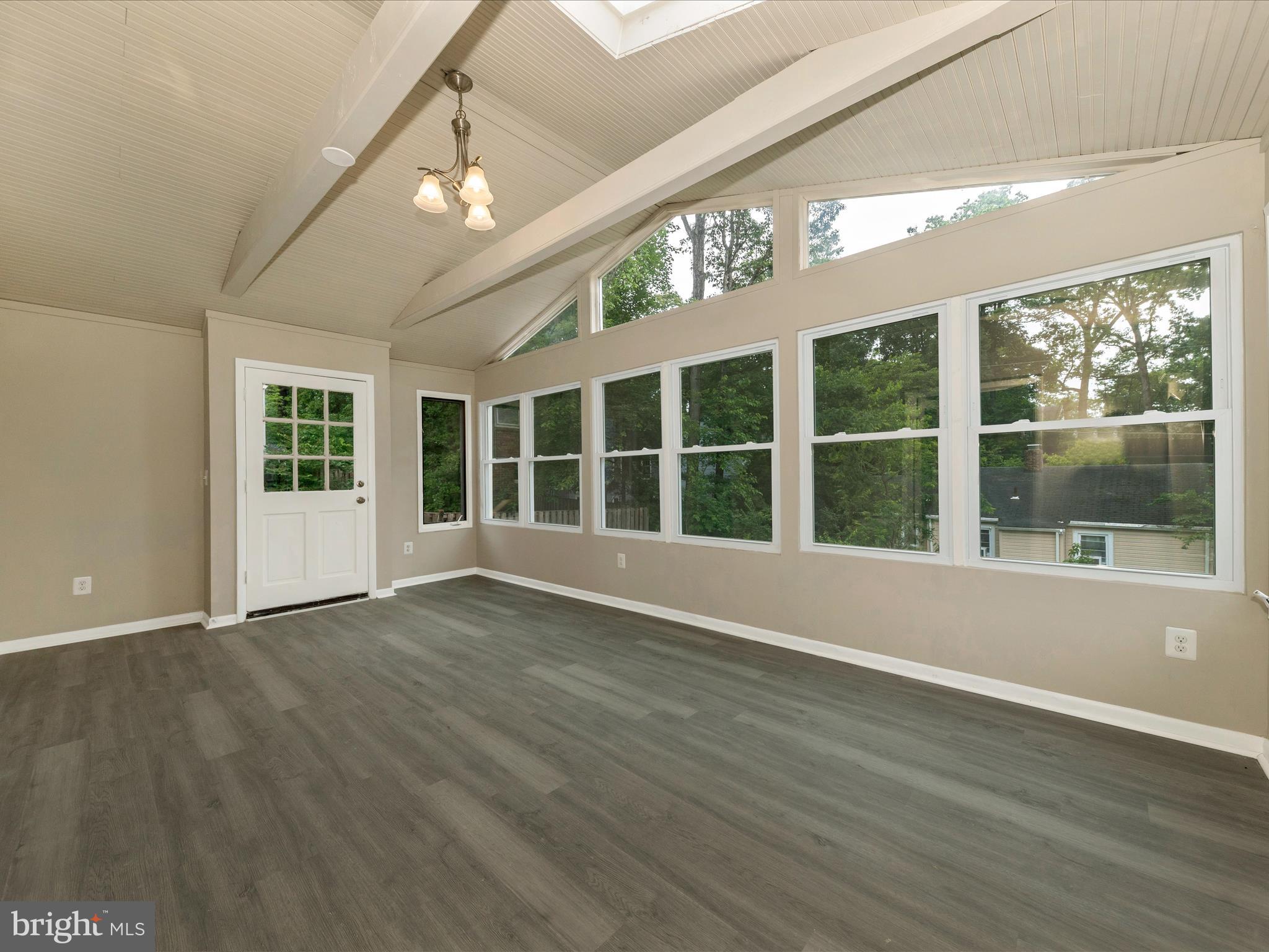 8709 Bradford Road Silver Spring, MD 20901 - Photo 12 of 51 a view of an empty room with wooden floor and a window