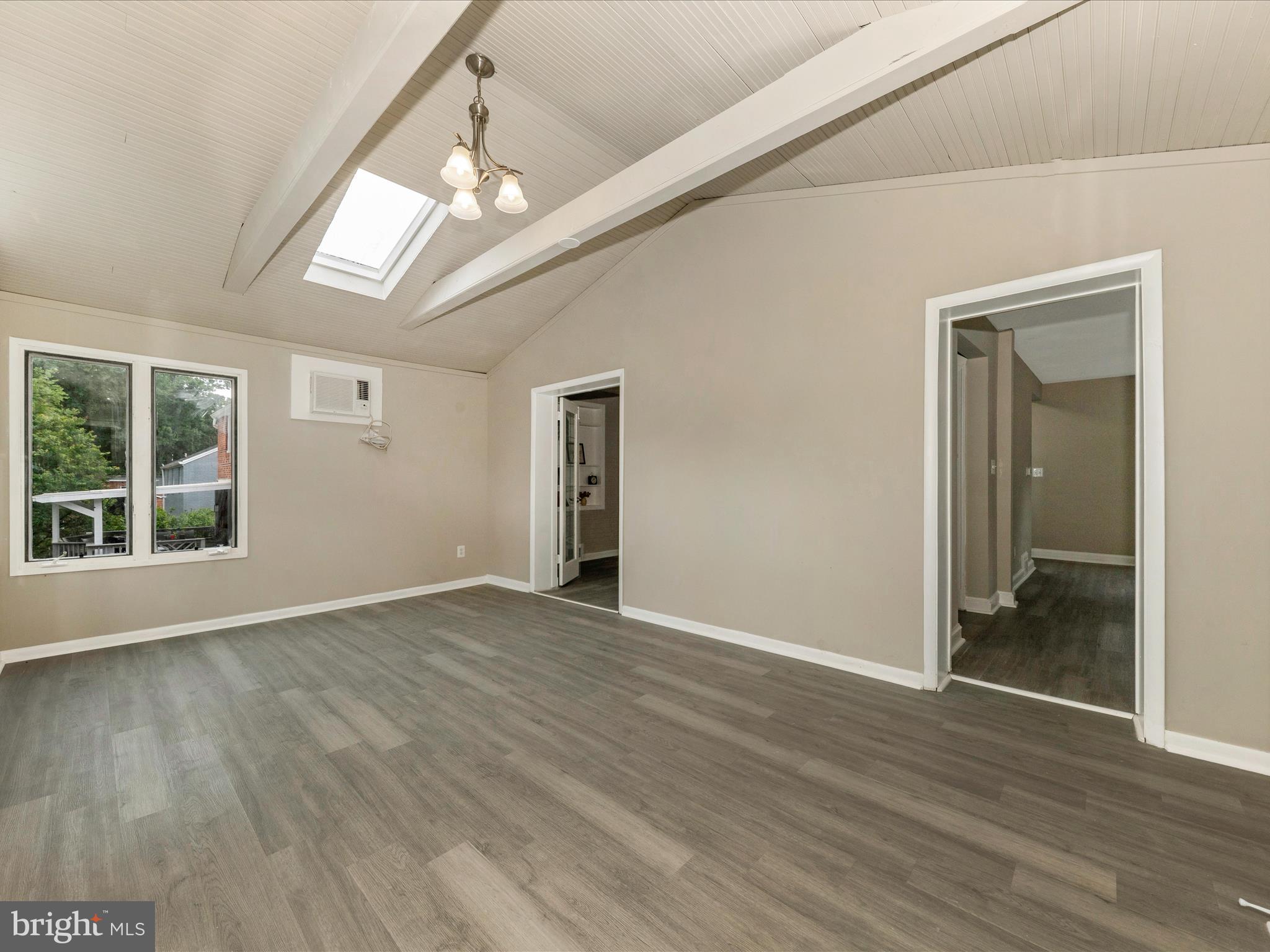 8709 Bradford Road Silver Spring, MD 20901 - Photo 13 of 51 a view of an empty room with wooden floor and a window