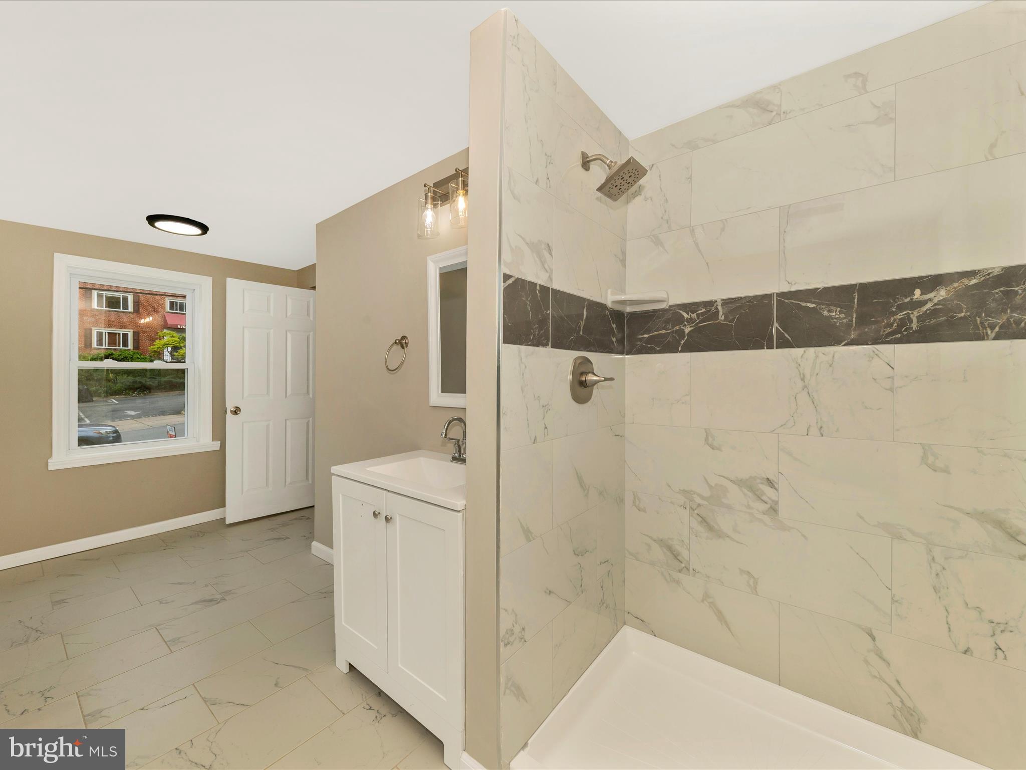 8709 Bradford Road Silver Spring, MD 20901 - Photo 22 of 51 a bathroom with a bathtub and a shower