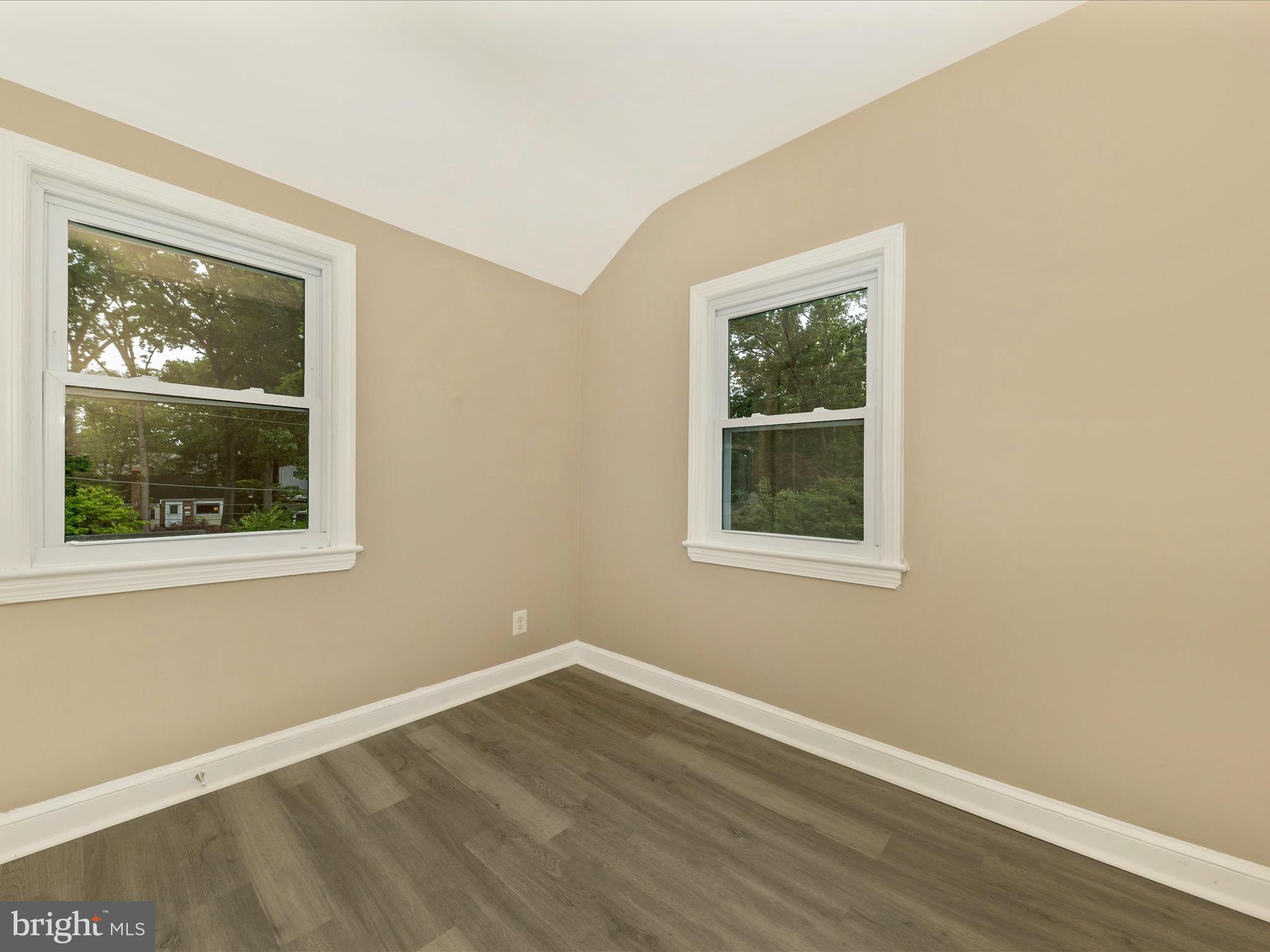 8709 Bradford Road Silver Spring, MD 20901 - Photo 27 of 51 a view of an empty room with wooden floor and a window