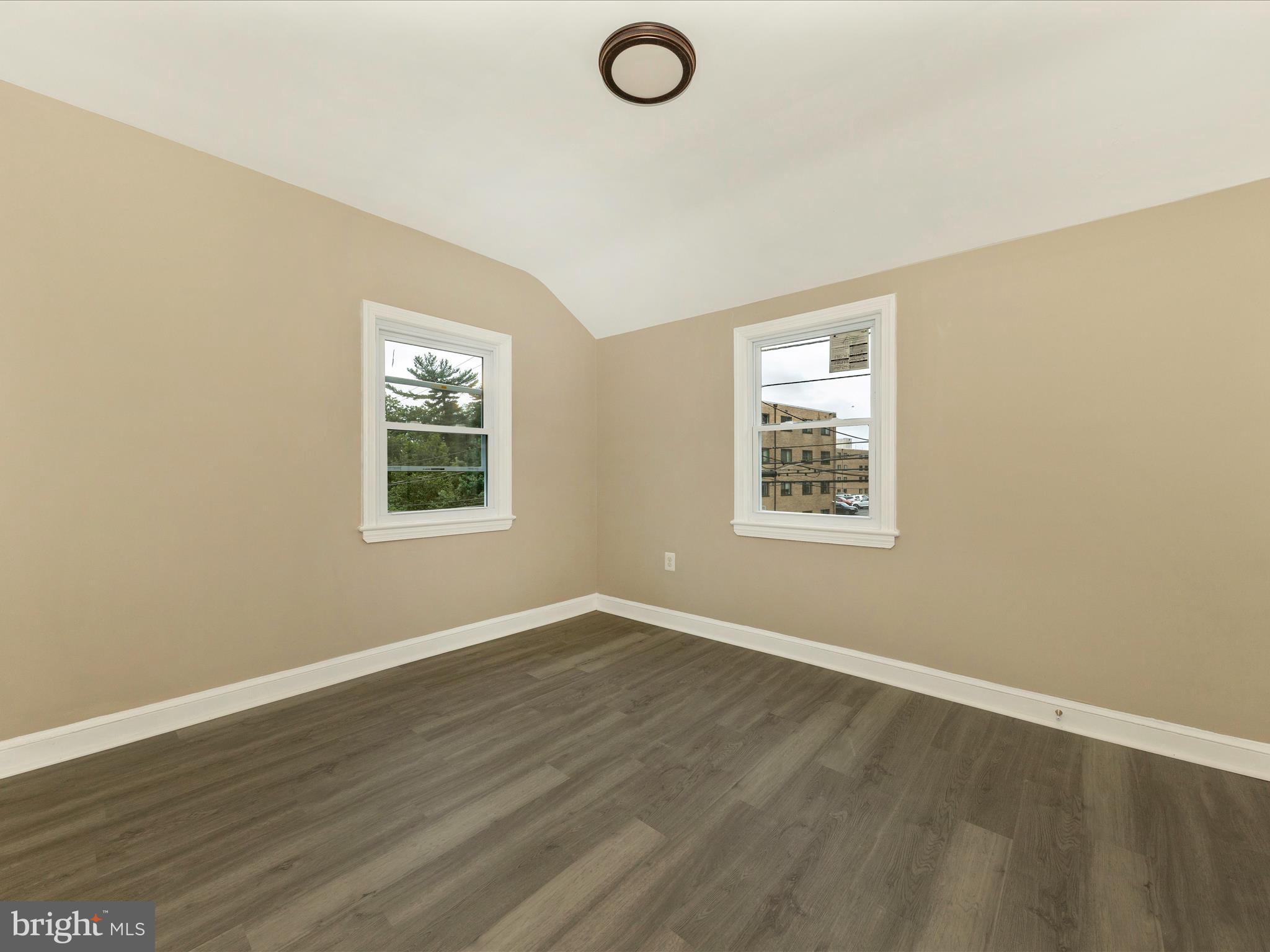 8709 Bradford Road Silver Spring, MD 20901 - Photo 29 of 51 an empty room with wooden floor and windows