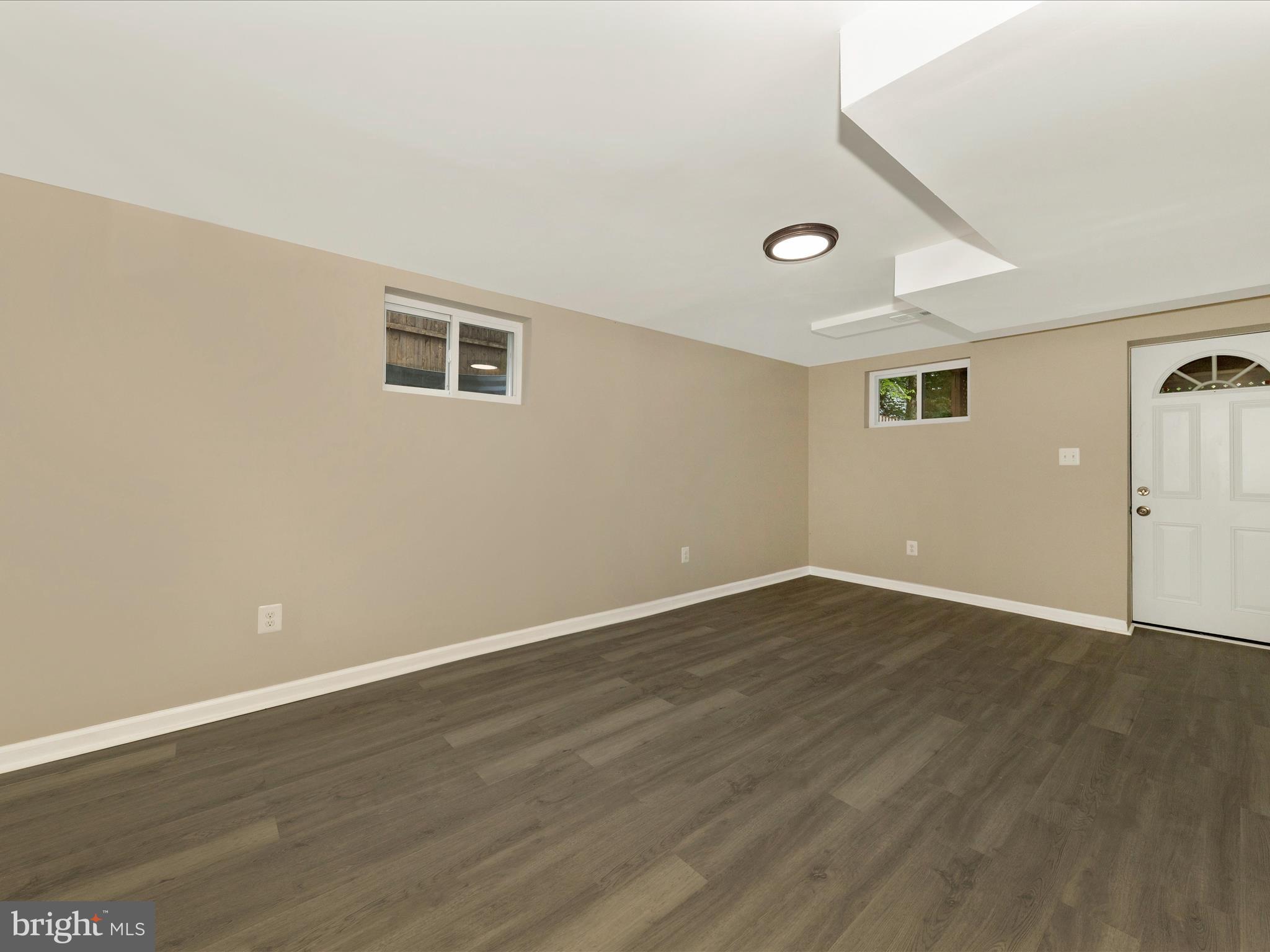 8709 Bradford Road Silver Spring, MD 20901 - Photo 33 of 51 a view of an empty room with wooden floor