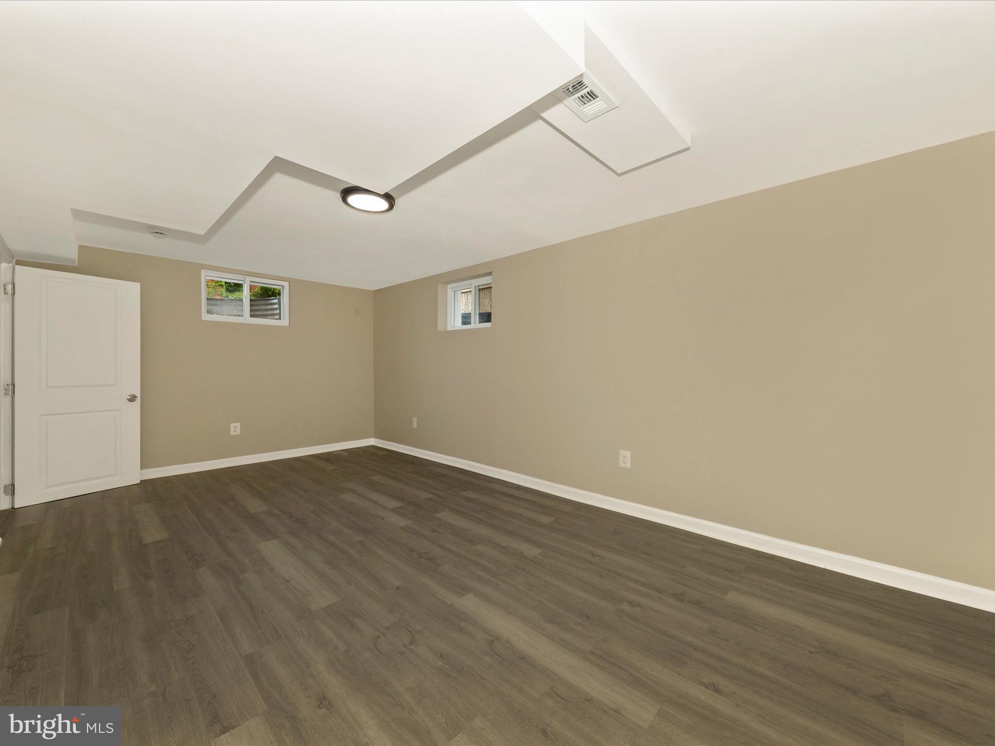 8709 Bradford Road Silver Spring, MD 20901 - Photo 35 of 51 a view of an empty room with wooden floor and a ceiling fan
