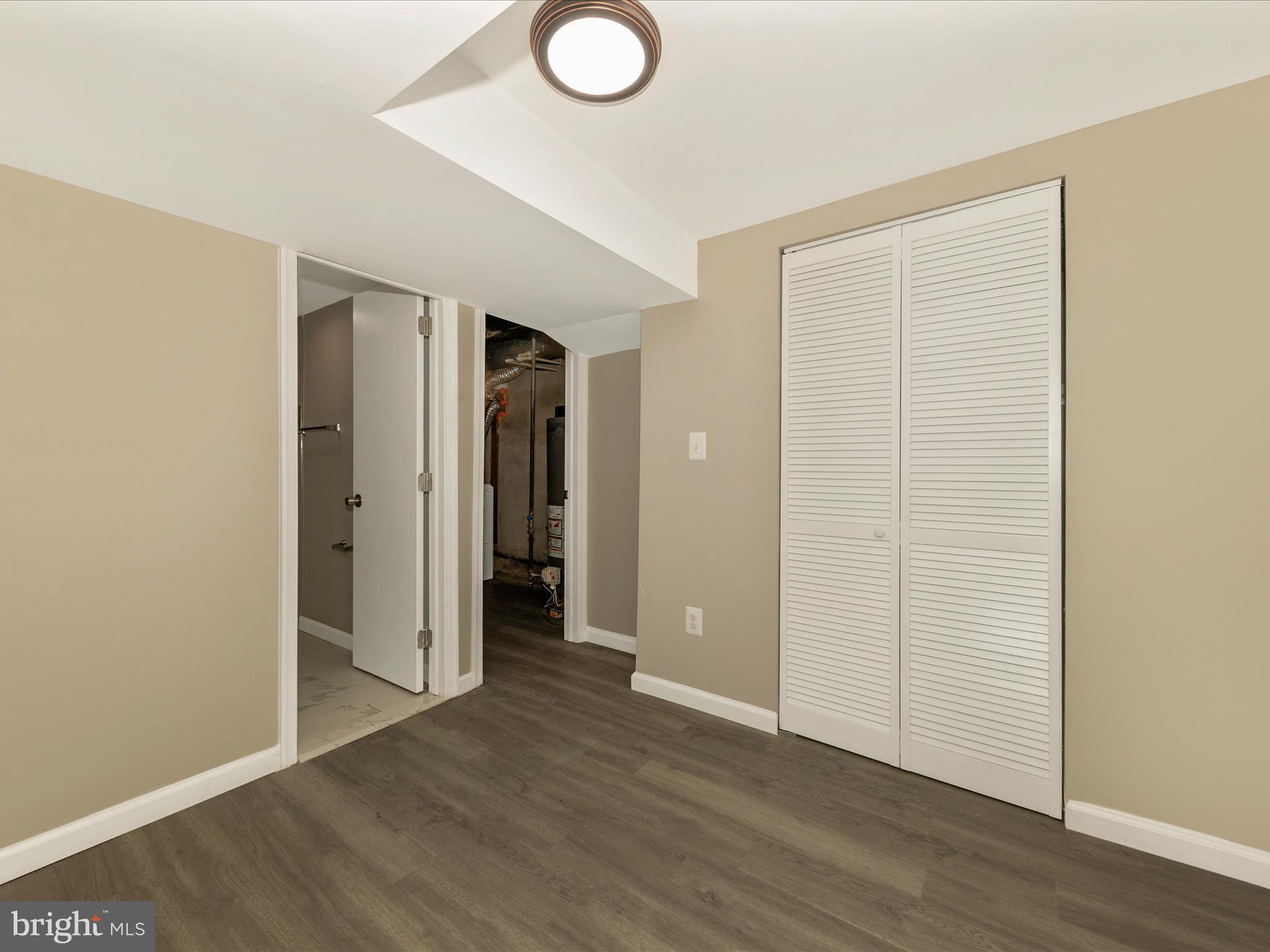8709 Bradford Road Silver Spring, MD 20901 - Photo 36 of 51 an empty room with wooden floor and closet