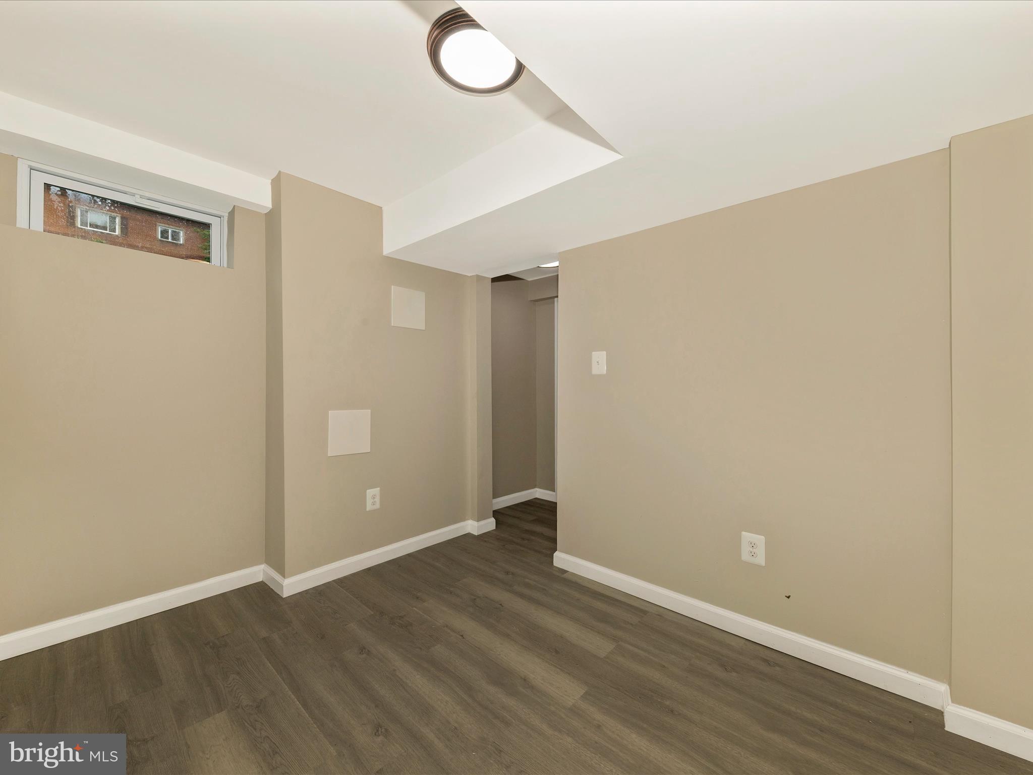 8709 Bradford Road Silver Spring, MD 20901 - Photo 37 of 51 a view of an empty room with wooden floor
