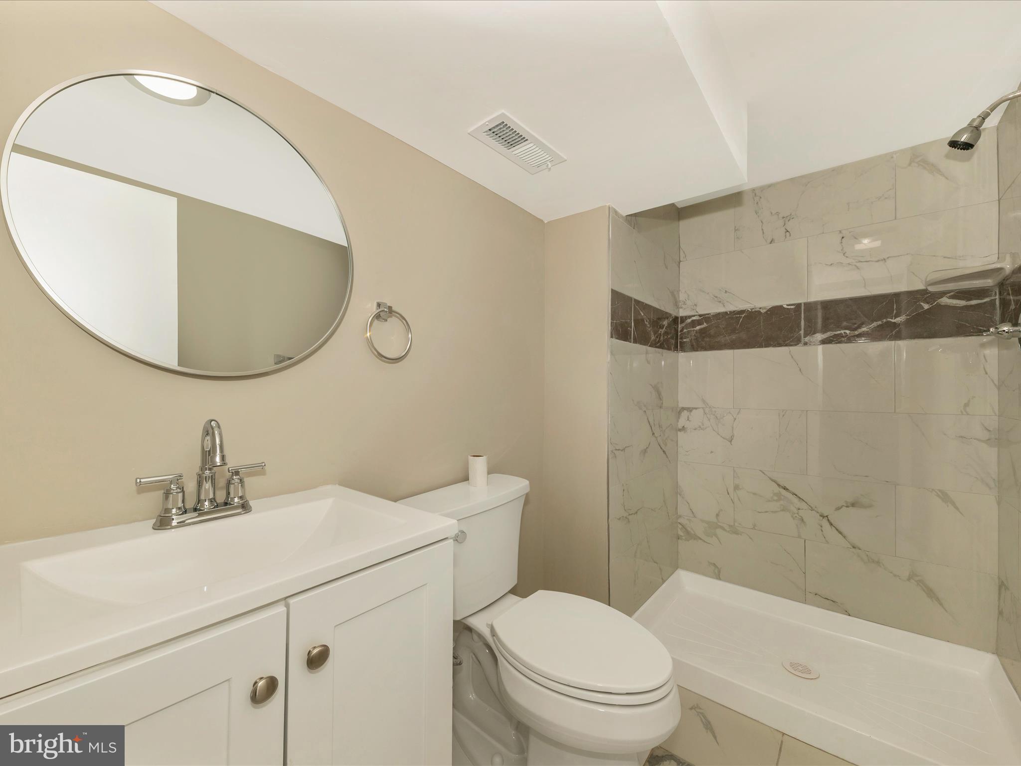 8709 Bradford Road Silver Spring, MD 20901 - Photo 38 of 51 a bathroom with a sink toilet and shower