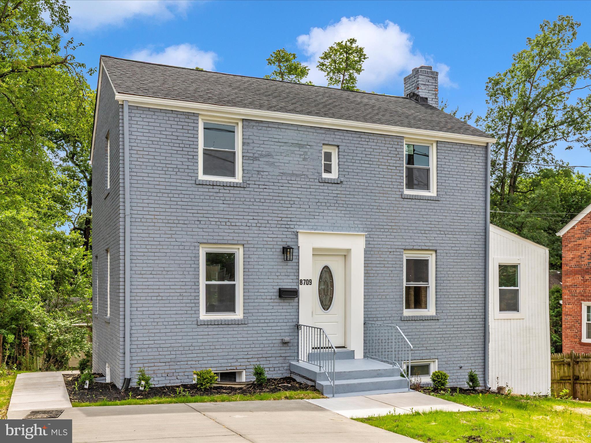 8709 Bradford Road Silver Spring, MD 20901 - Photo 43 of 51 a front view of a house with a yard and garage