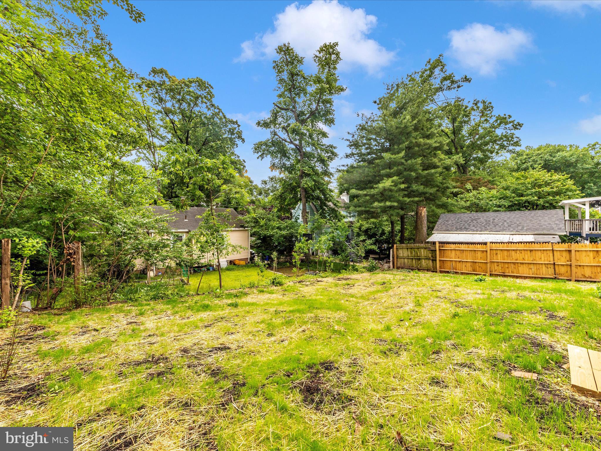 8709 Bradford Road Silver Spring, MD 20901 - Photo 50 of 51 a backyard of a house with a yard and fountain in middle