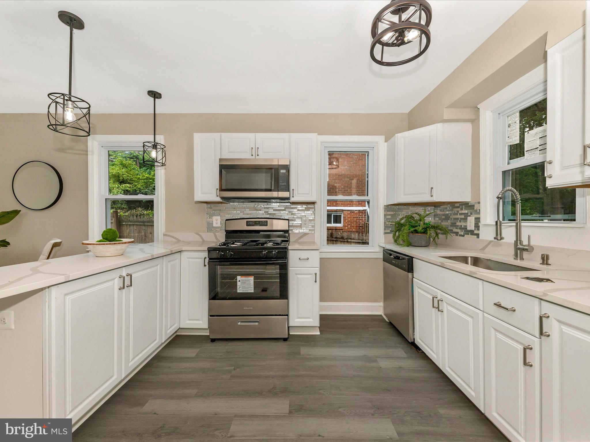 8709 Bradford Road Silver Spring, MD 20901 - Photo 7 of 51 a kitchen with a sink stove and microwave