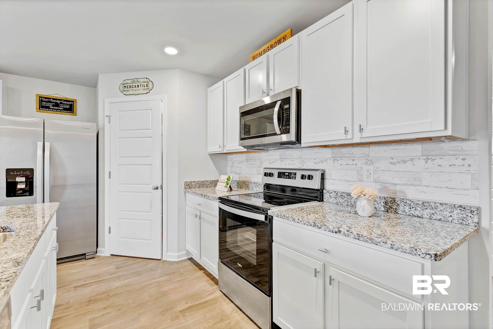 17217 REFLECTION Street Loxley, AL 36551 - Photo 13 of 83 Kitchen featuring stainless steel appliances, white cabinetry, tasteful backsplash, light stone counters, and recessed lighting