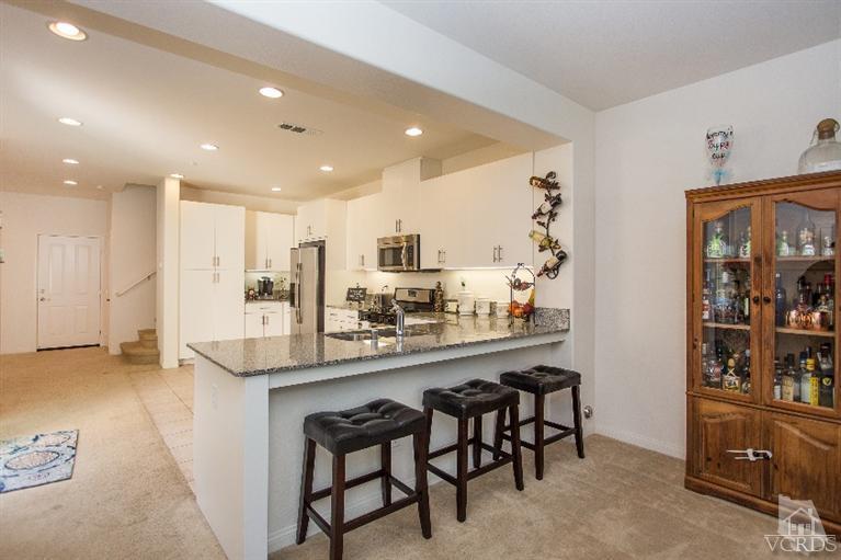 3012 North Ventura Road Oxnard, CA 93036 - Photo 2 of 29 a kitchen with kitchen island cabinets and chairs in it
