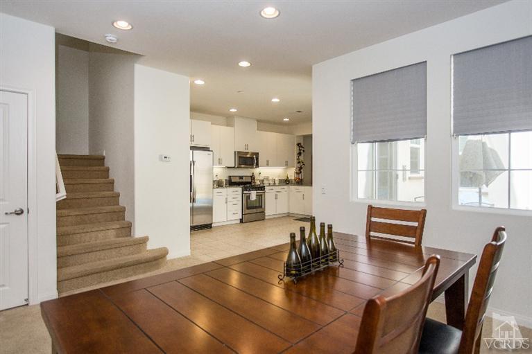 3012 North Ventura Road Oxnard, CA 93036 - Photo 5 of 29 a kitchen with a dining table chairs and refrigerator