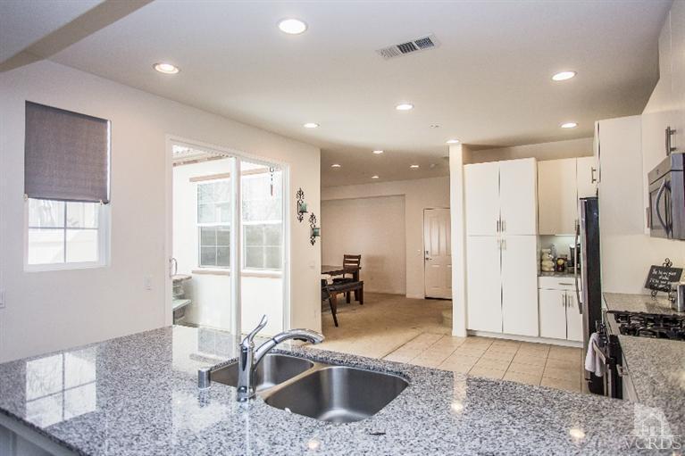 3012 North Ventura Road Oxnard, CA 93036 - Photo 9 of 29 a kitchen with stainless steel appliances granite countertop a sink a stove and a refrigerator