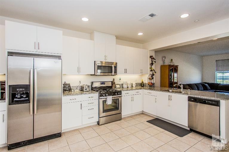 3012 North Ventura Road Oxnard, CA 93036 - Photo 10 of 29 a kitchen with white cabinets stainless steel appliances and a sink