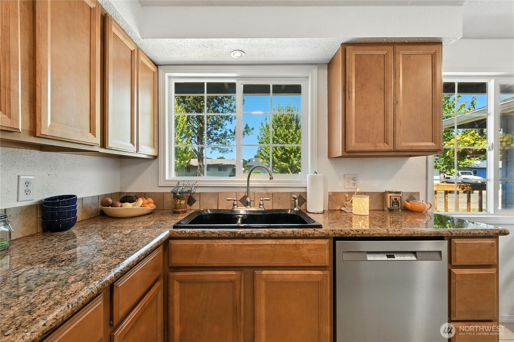 2102 35th Avenue Longview, WA 98632 - Photo 11 of 31 a kitchen with granite countertop cabinets sink and window