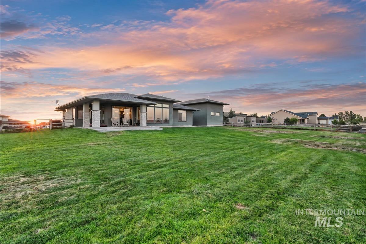 24398 Tombstone Ridge Court Middleton, ID 83644 - Photo 36 of 48 Expansive green lawn surrounds a contemporary residence with a covered patio