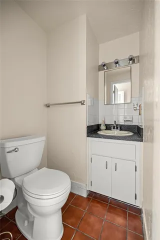 a bathroom with a toilet a sink and shower