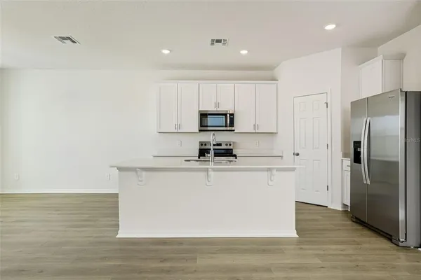 a kitchen with sink and cabinets